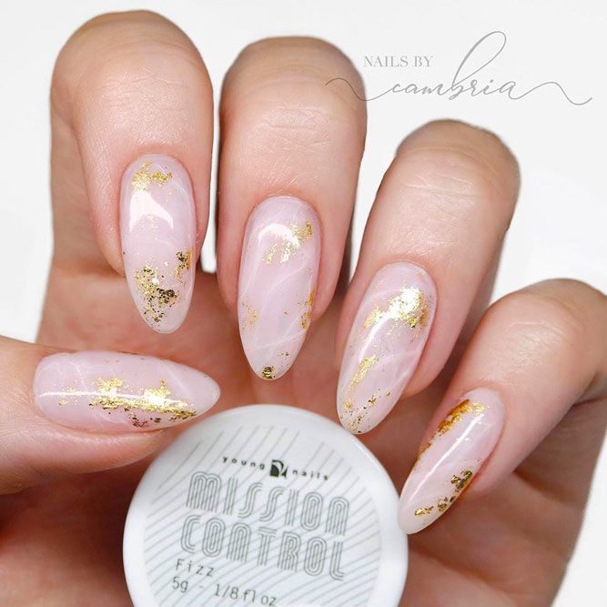 Sophisticated Almond-Shaped Nail Design with Soft Pink Base and Shimmering Gold Flakes.