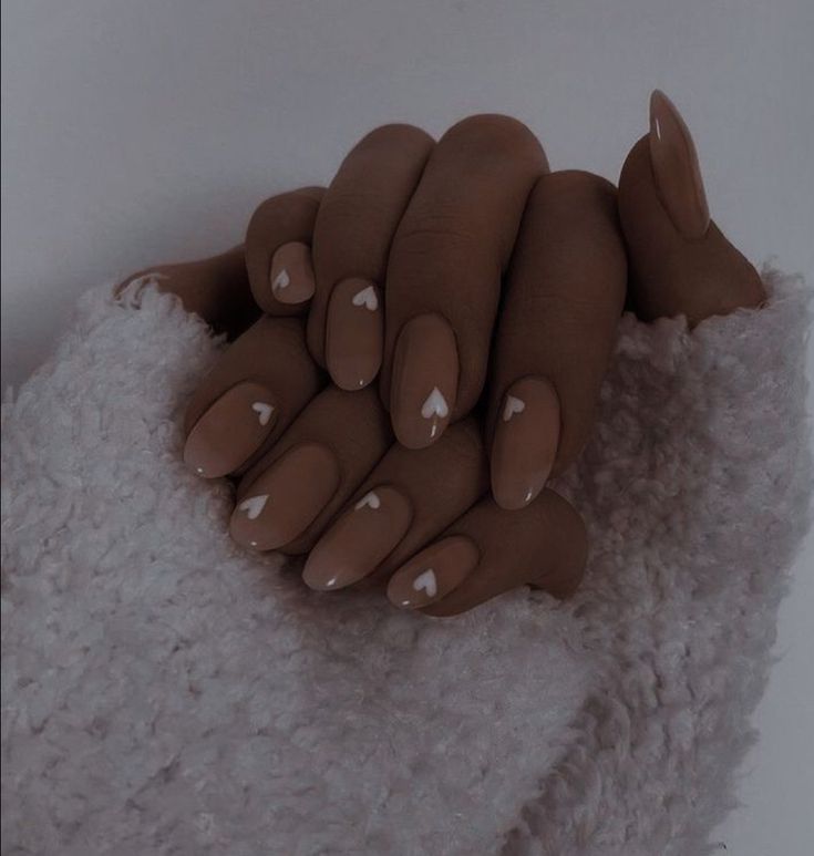 Elegant Nude Nail Design with Chic White Heart Accents