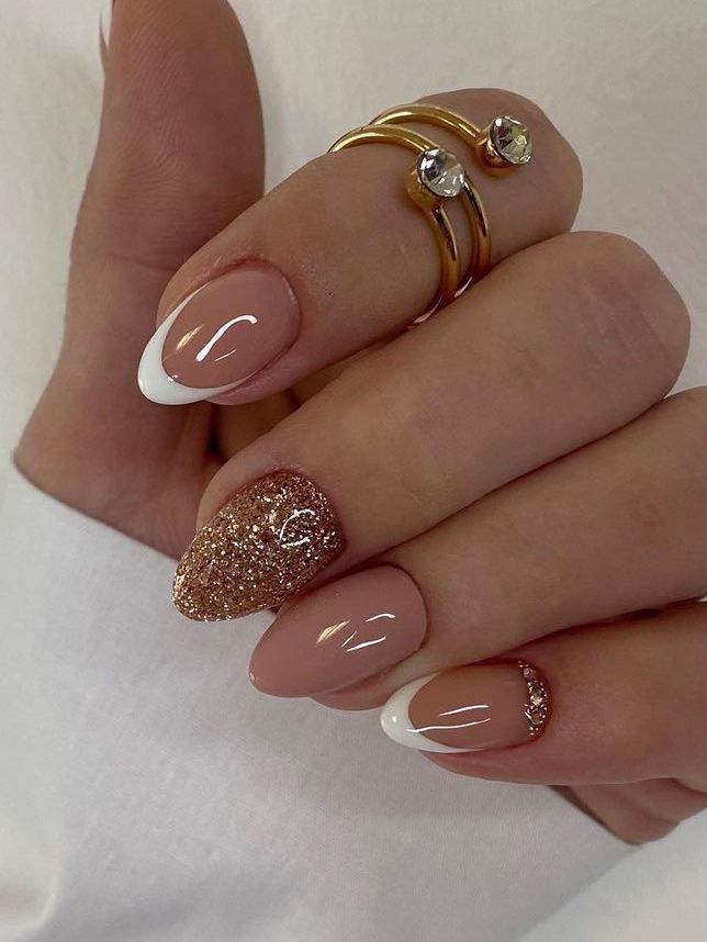 Sophisticated Nude Nail Design with Delicate Tips, Glitter Accent, and Gold Rings.