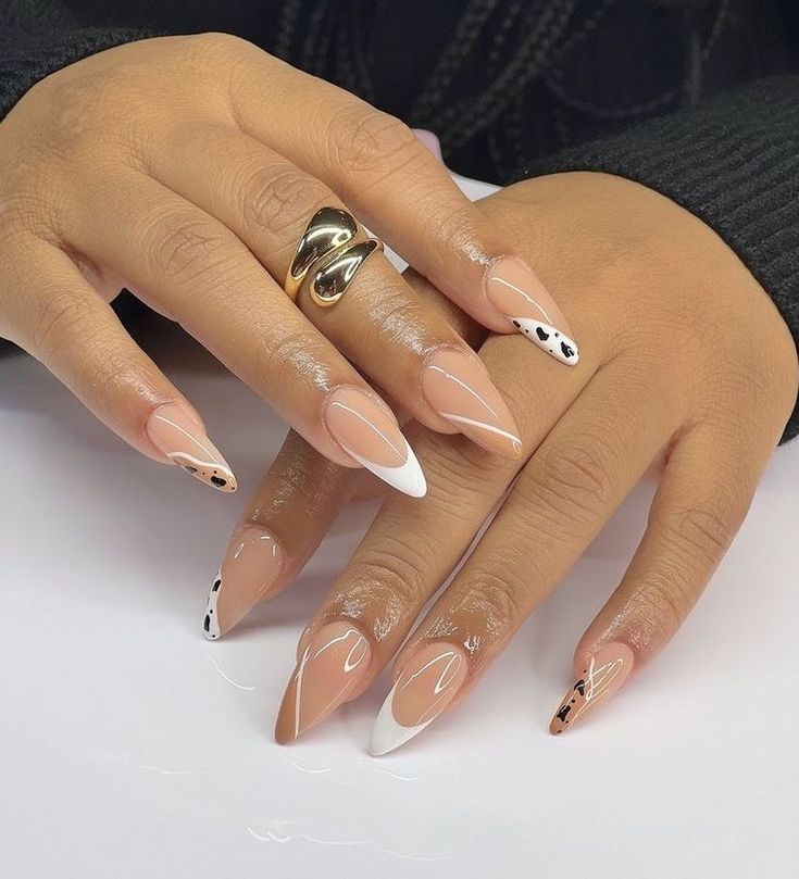 Chic Almond-Shaped Manicure: Soft Nude Base with Bold White Tips and Artistic Flair.