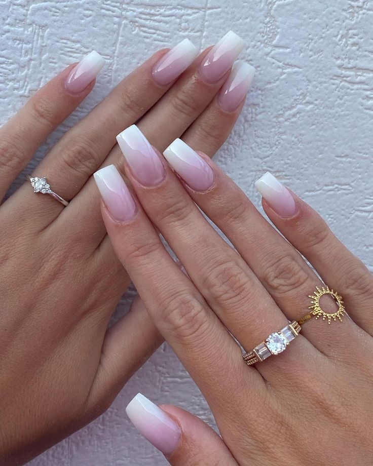 Sophisticated French Tip Nail Design with Gradient Effect and Delicate Accessories.