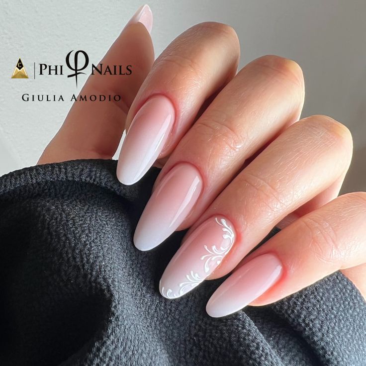 Sophisticated Almond-Shaped Ombre Nails with Floral Accent and Glossy Finish.