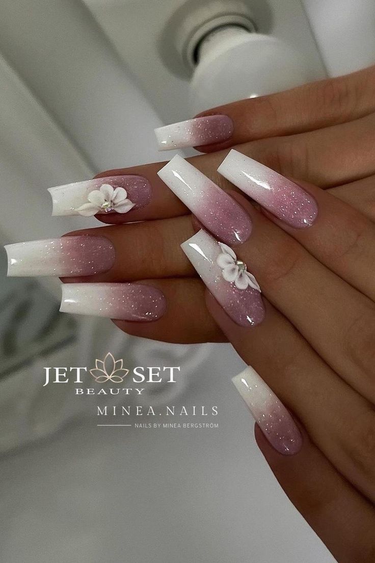 Sophisticated Ombre Nails with Floral Accents in Soft Pink and White.