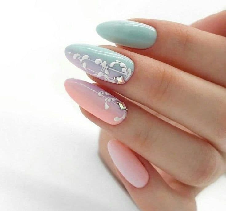 Chic Pastel Nail Design with Floral Patterns and Metallic Accents