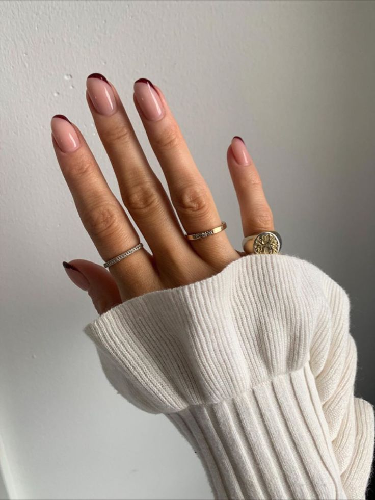 Chic Nail Design: Subtle Nude Base with Striking Burgundy Tips for a Polished Look.