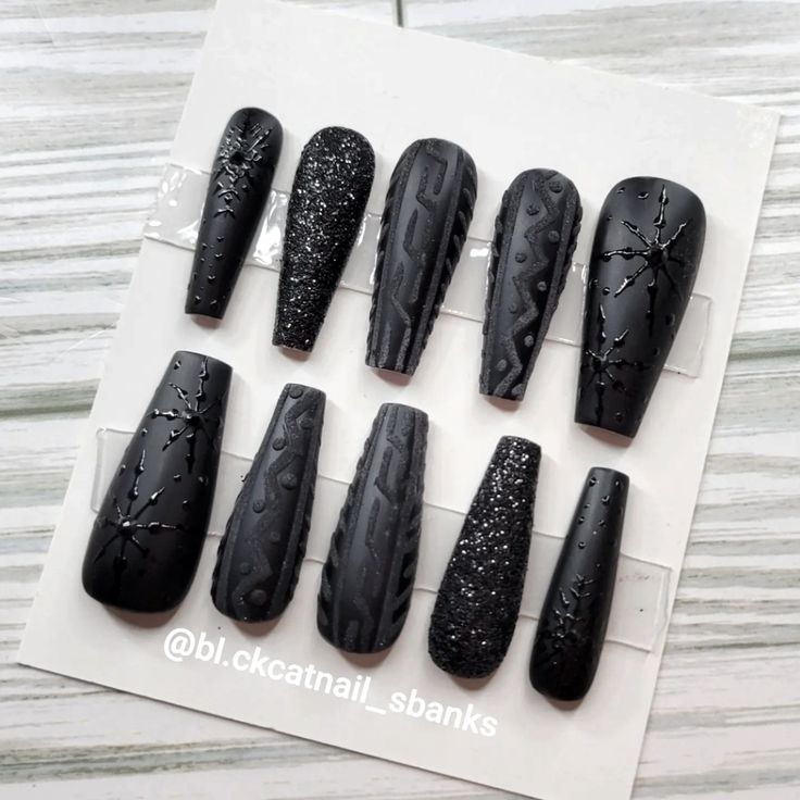 Edgy Matte Black Nail Design: A Striking Blend of Unique Textures and Patterns.