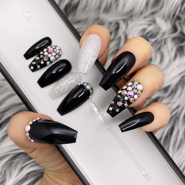 Striking Bold Black and Shimmering Silver Nail Design with Rhinestones for Elegant Occasions.