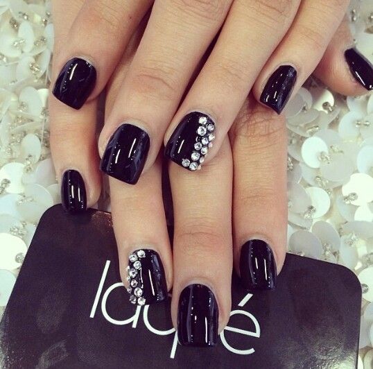 Chic Black Manicure with Glossy Finish and Glamorous Rhinestone Accents.