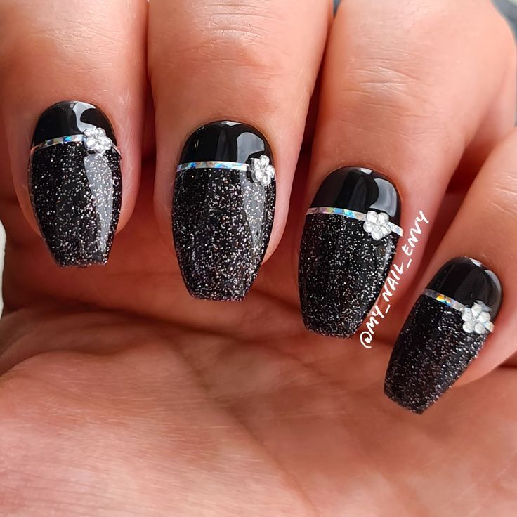 Elegant Glittery Black Nails with Floral Accents for Striking Sophistication.