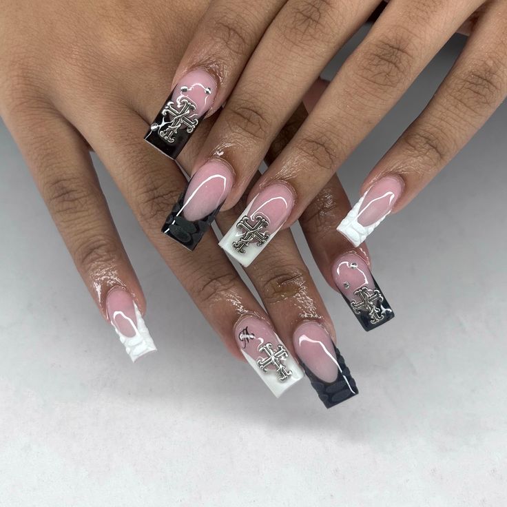 Chic Elongated Nail Design with Nude, Black, White Colors, and Silver Embellishments