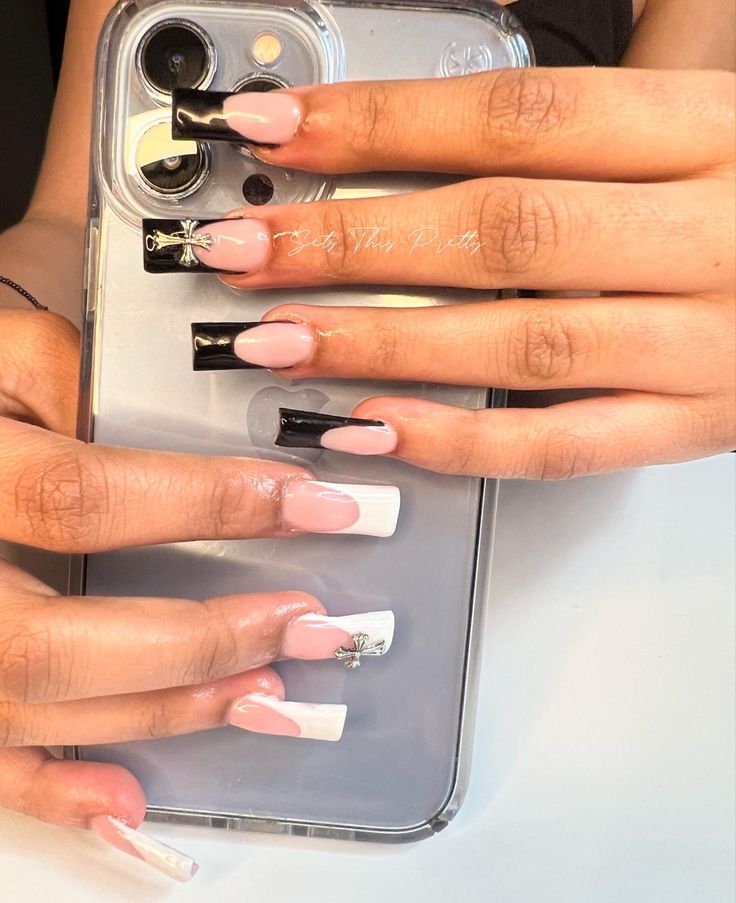 Chic Nail Art: Bold Black and White Meets Soft Pink with Silver Accents.