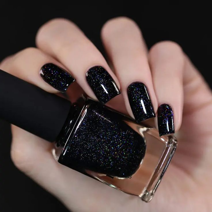 Glistening Black Nails with Striking Holographic Effect for Glamorous Occasions.