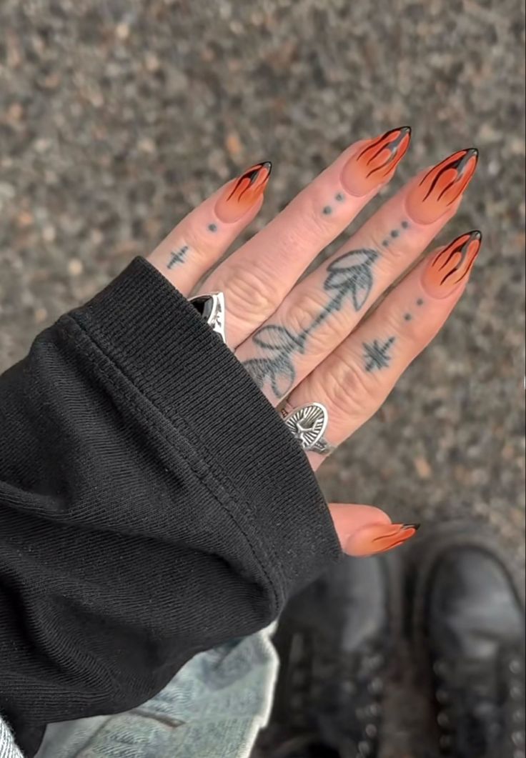 Bold Flame-Inspired Nail Design with Orange and Black Gradient for a Fierce Look.