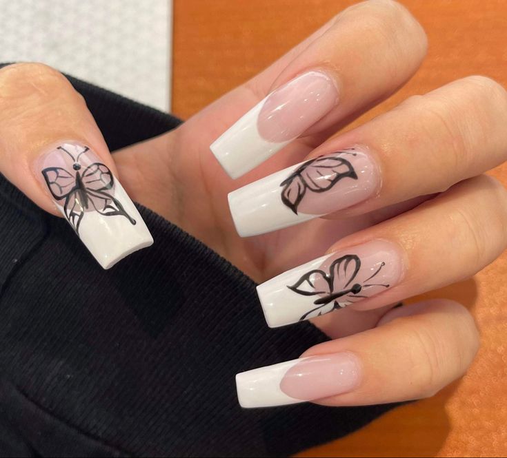 Elegant Nail Design with Clear and White Tips Accented by Whimsical Butterfly Illustrations.