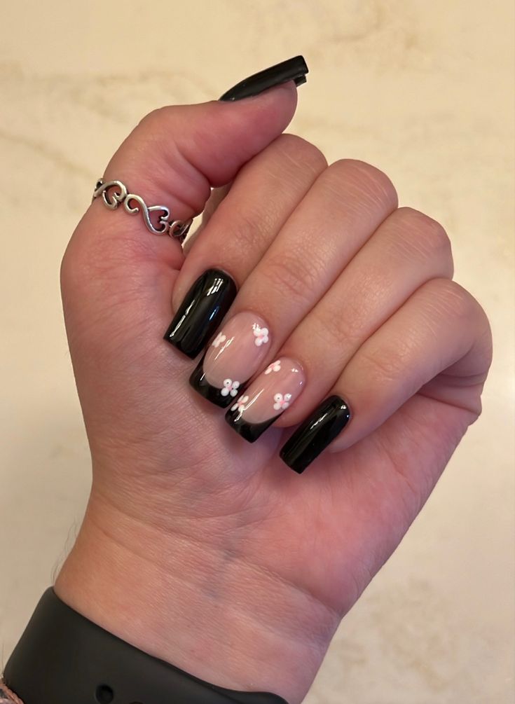 Chic Black and Nude Nail Design with Floral Accents