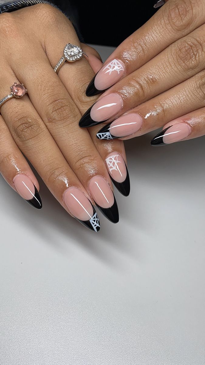 Stylish Almond-Shaped Nail Design: Nude and Black with Creative Spider Web Motifs.