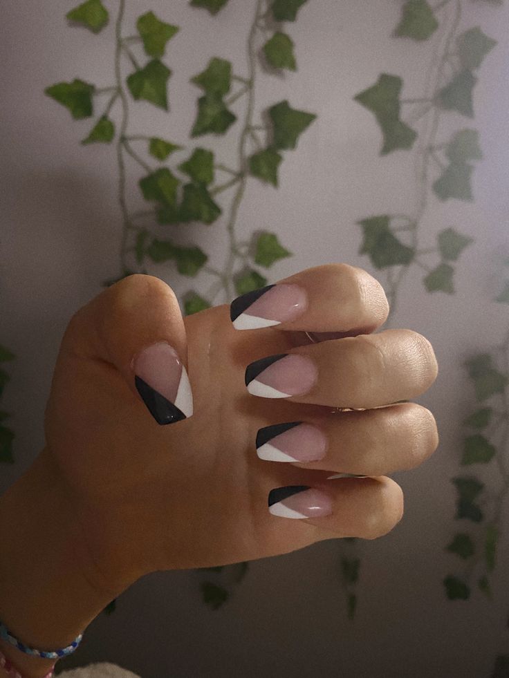 Chic Pastel Pink, White, and Black Geometric Nail Design with Bold Tips.