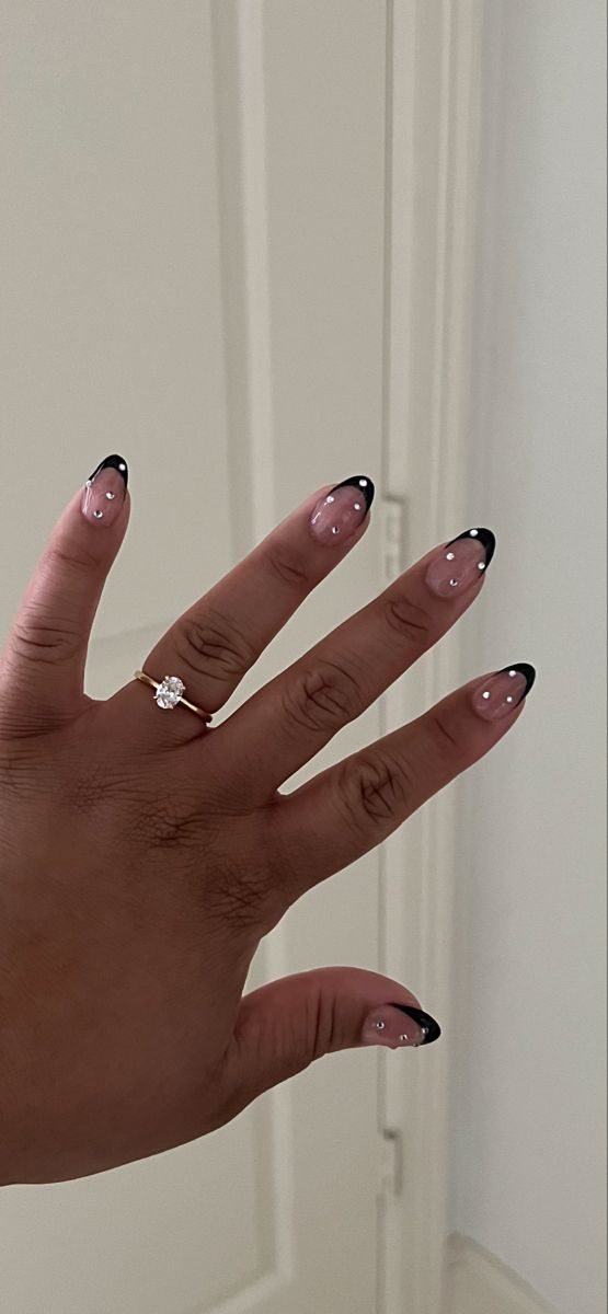 Chic French Tip Nail Design with Pearlescent Glamour and Modern Black Tips.