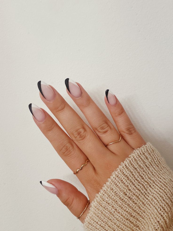 Chic Soft Pink and Black Tip Nail Design with Elegant Accent Rings.