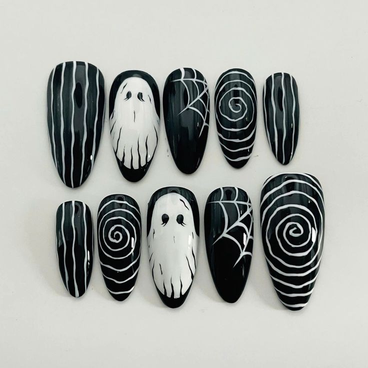 Spooky Chic: Halloween-Inspired Black and White Nail Design with Ghosts and Spider Webs