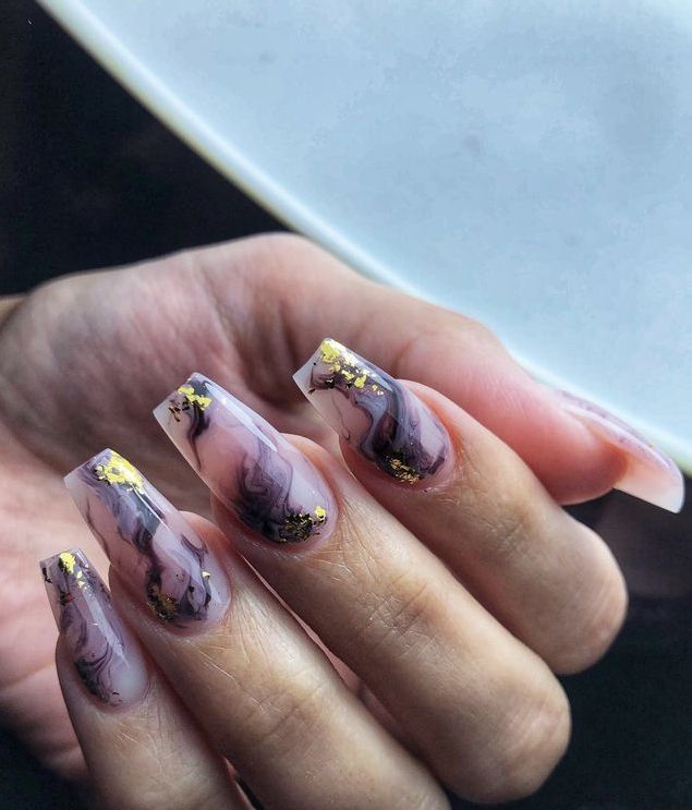 Sophisticated Translucent Marble Nail Design with Gold Flakes in Elongated Coffin Shape.