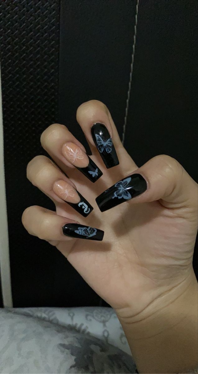 Elegant Bold Black and Soft Nude Nail Art with Floral and Butterfly Motifs on Long Squared Nails.