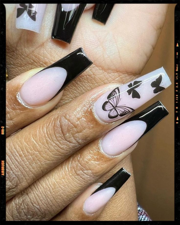 Sophisticated Nail Design: Glossy Black Tips, Soft Pink Base & Whimsical Butterfly Patterns