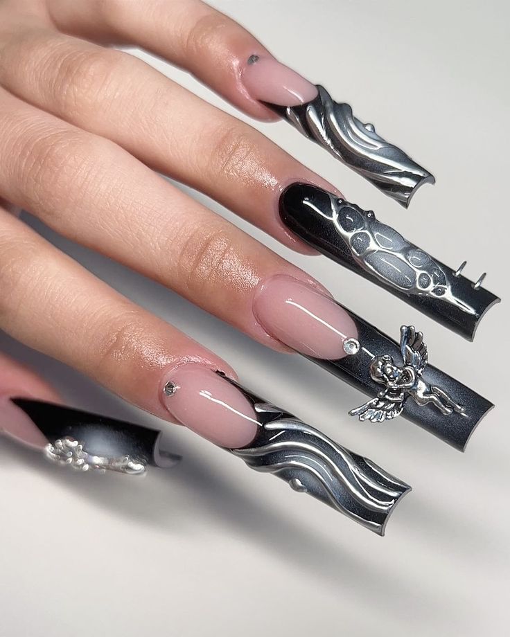 Dramatic Striking Nail Art: Glossy Black and Nude with Silver Accents and Unique Wave Patterns.