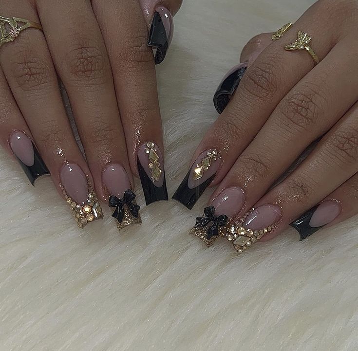 Chic Nude and Black Nail Design with Glamorous Pearls and Bows.