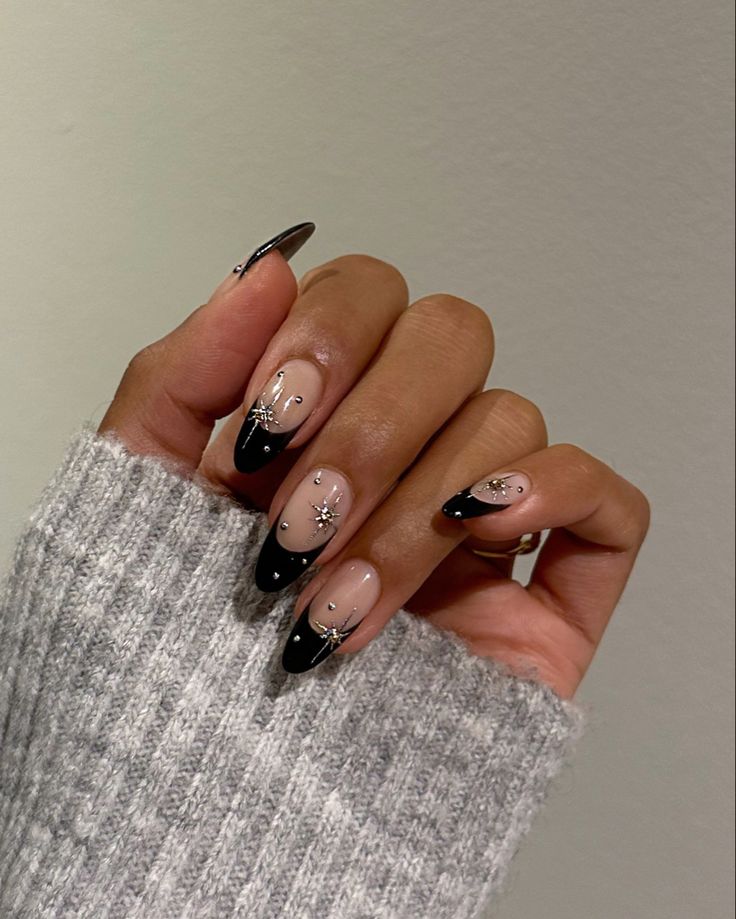 Sophisticated Elegant Nail Design: Nude and Black with Silver Embellishments.