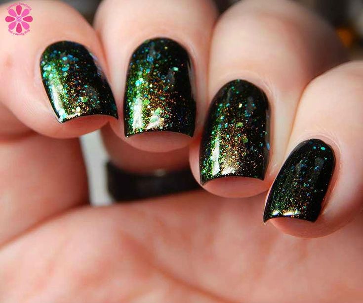 Glamorous Black Nail Design with Shimmering Green and Gold Glitter Accents