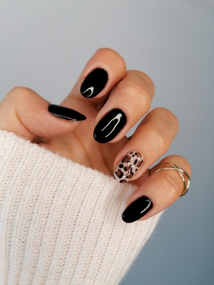 Chic Black Nail Design with Glossy, Matte Finishes and Trendy Leopard Accent.