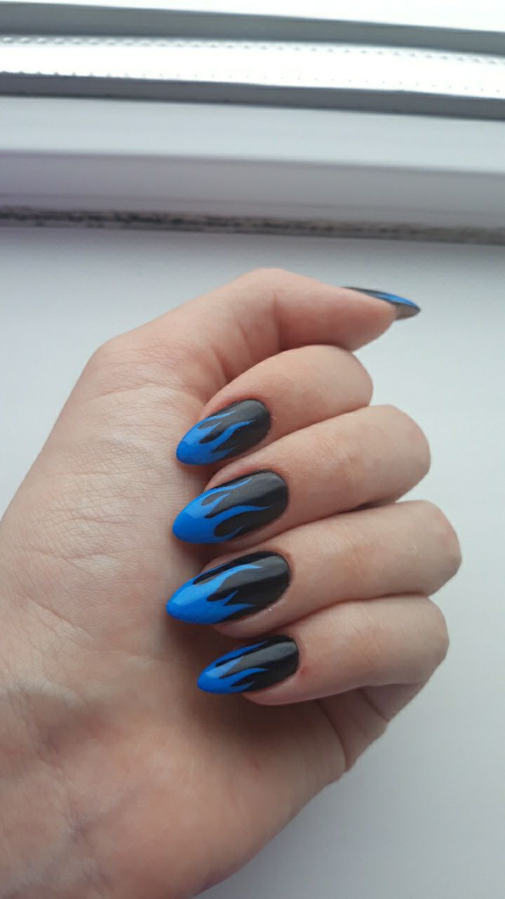 Bold Flame-Inspired Nail Design with Matte Black and Vibrant Blue Accents.