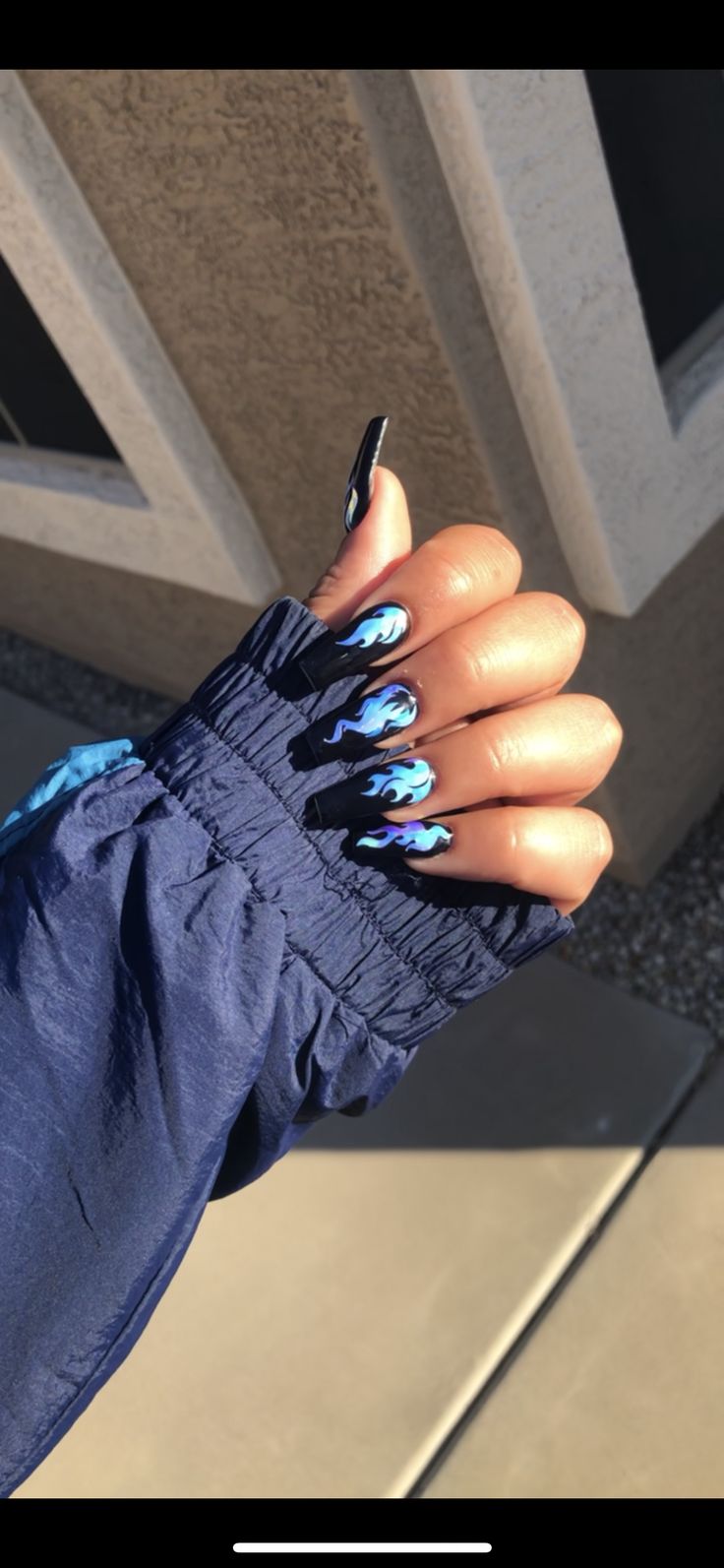 Bold Flame-Inspired Nail Design: Striking Blue and Black Swirls for Everyday Style.