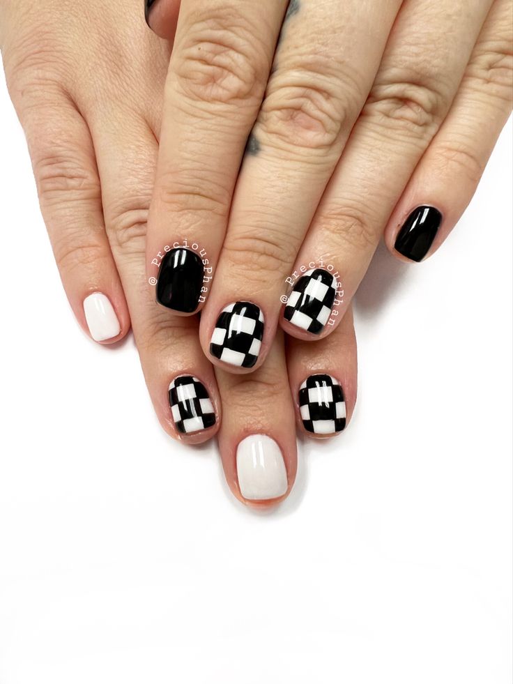 Chic Black and White Checkerboard Nail Design with Geometric Patterns.