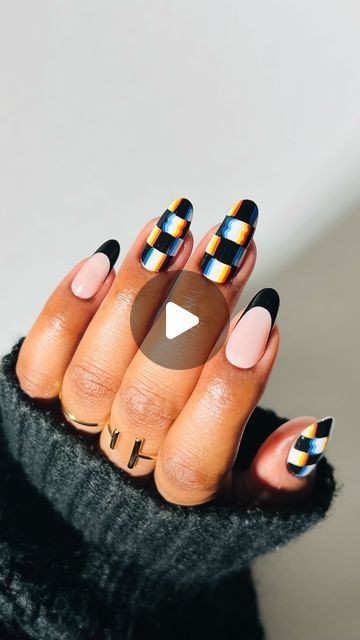 Chic Nail Design: Bold Black Tips with Glossy Multicolored Stripes and Elegant Nude Accents.