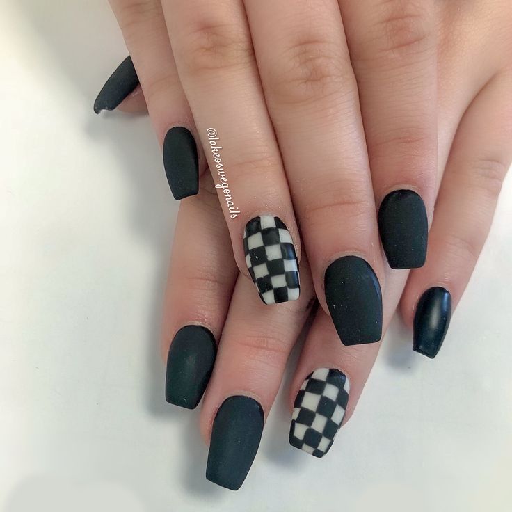 Bold Matte Black Nails with Striking Checkerboard Accent Design for a Chic Look.