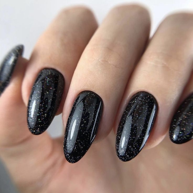 Chic Glittering Black Almond Nail Design for Bold Nighttime Elegance.