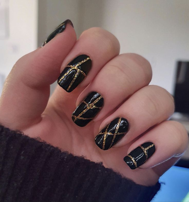 Elegant Chic Black Nail Design with Striking Gold Accents