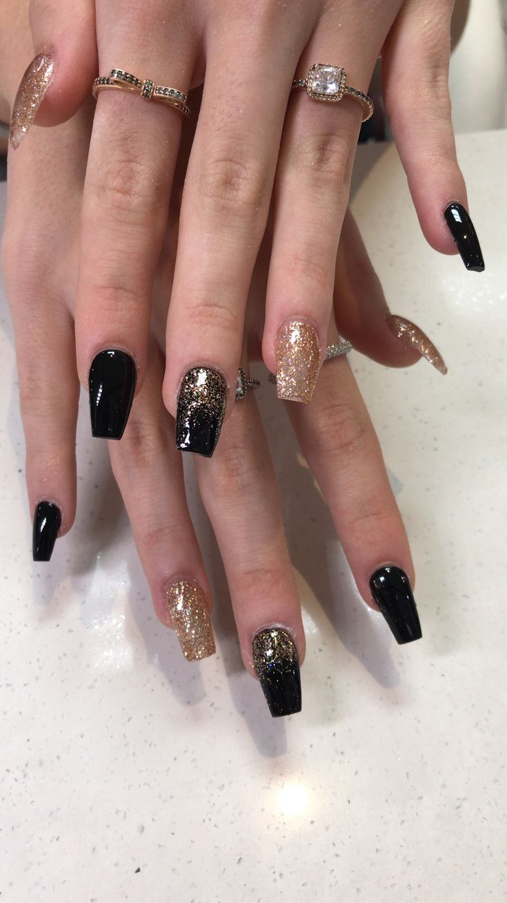 Chic Black and Gold Glitter Nail Design for Glamorous Occasions.