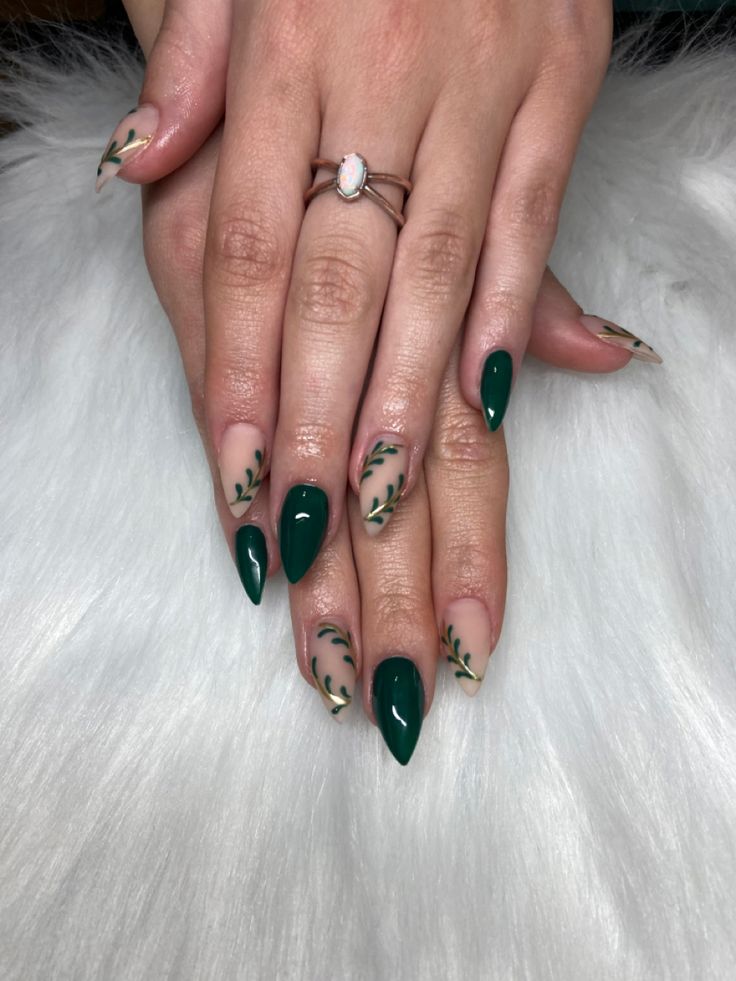 Chic Deep Green and Nude Nail Design with Delicate Leaf Patterns.