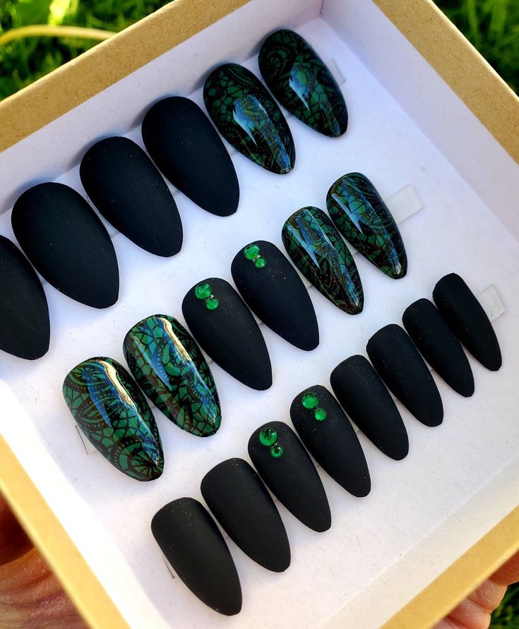 Bold Matte Black Nail Design with Intricate Green Accents for a Modern Statement Look