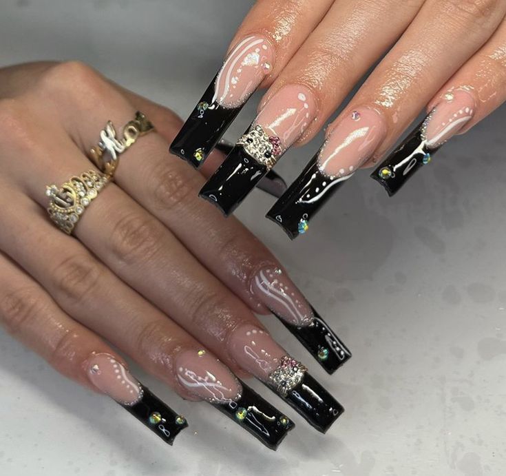 Elegant Long Nails with Striking Black and Clear Design Enhanced by Rhinestones.