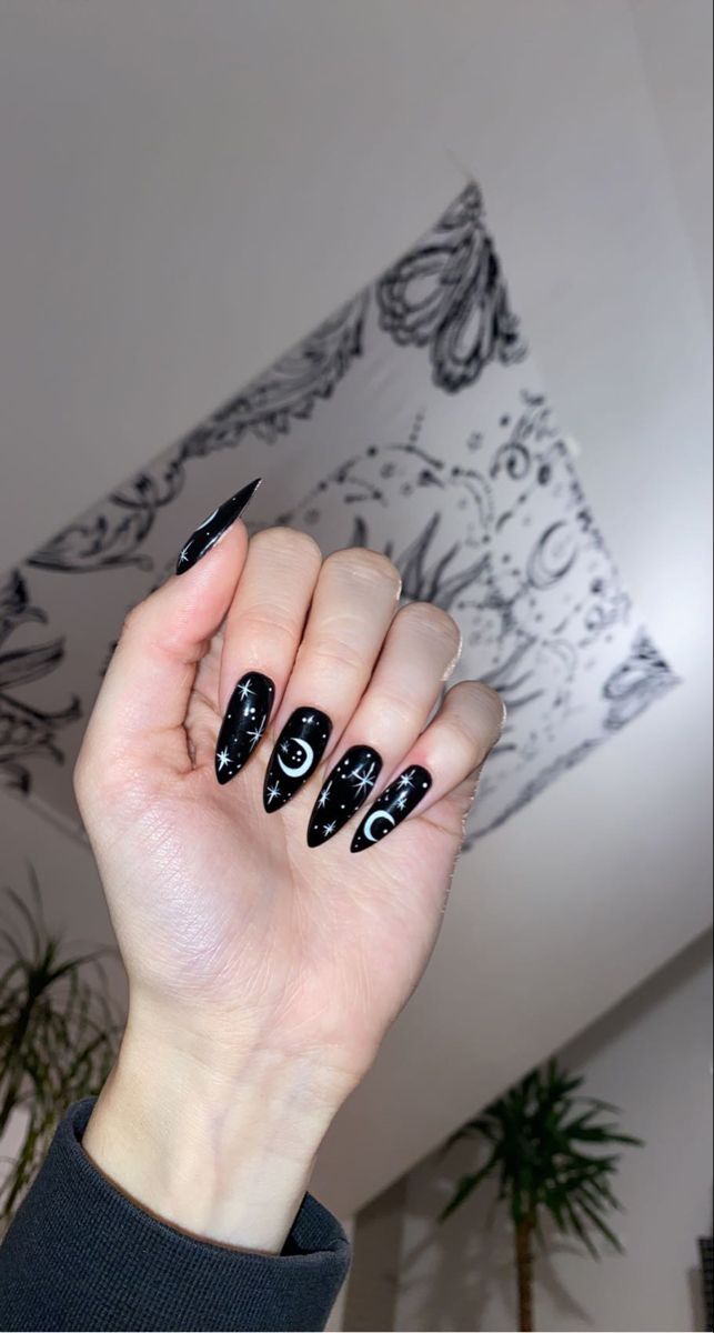 Ethereal Gothic Nail Art: Black Base with Celestial Motifs and Delicate White Accents