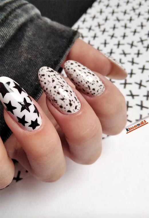 Trendy Black and White Nail Design with Bold Patterns and Textures.