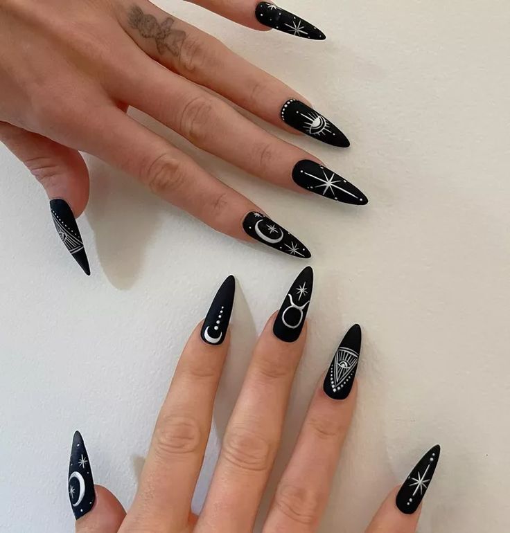 Elegant Celestial Black and White Nail Art with Intricate Designs