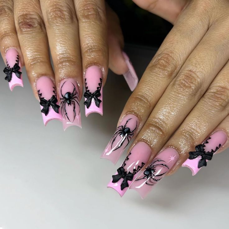 Striking Halloween Nail Art: Soft Pink Base with Black Spider and Bow Designs