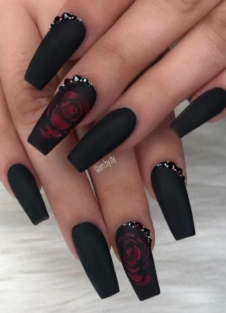 Sophisticated Matte Black Nails with Intricate Red Roses and Rhinestone Accents.