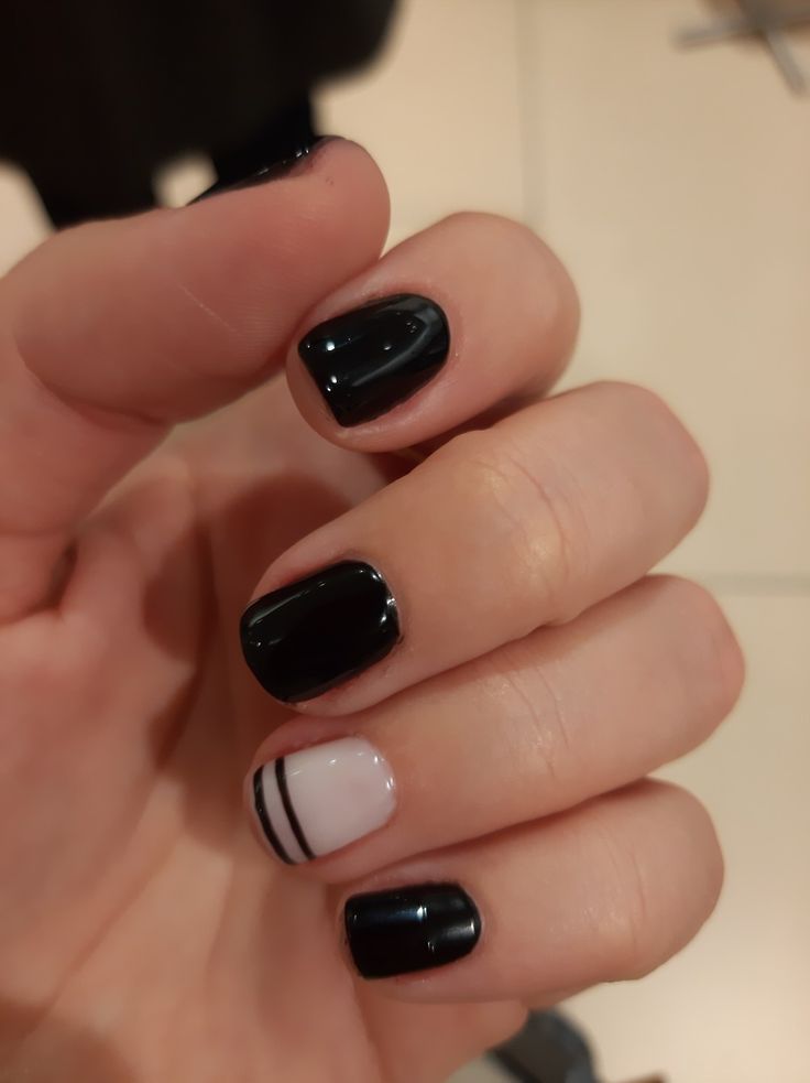 Chic Black and White Manicure Design with Minimalist Accent Nail