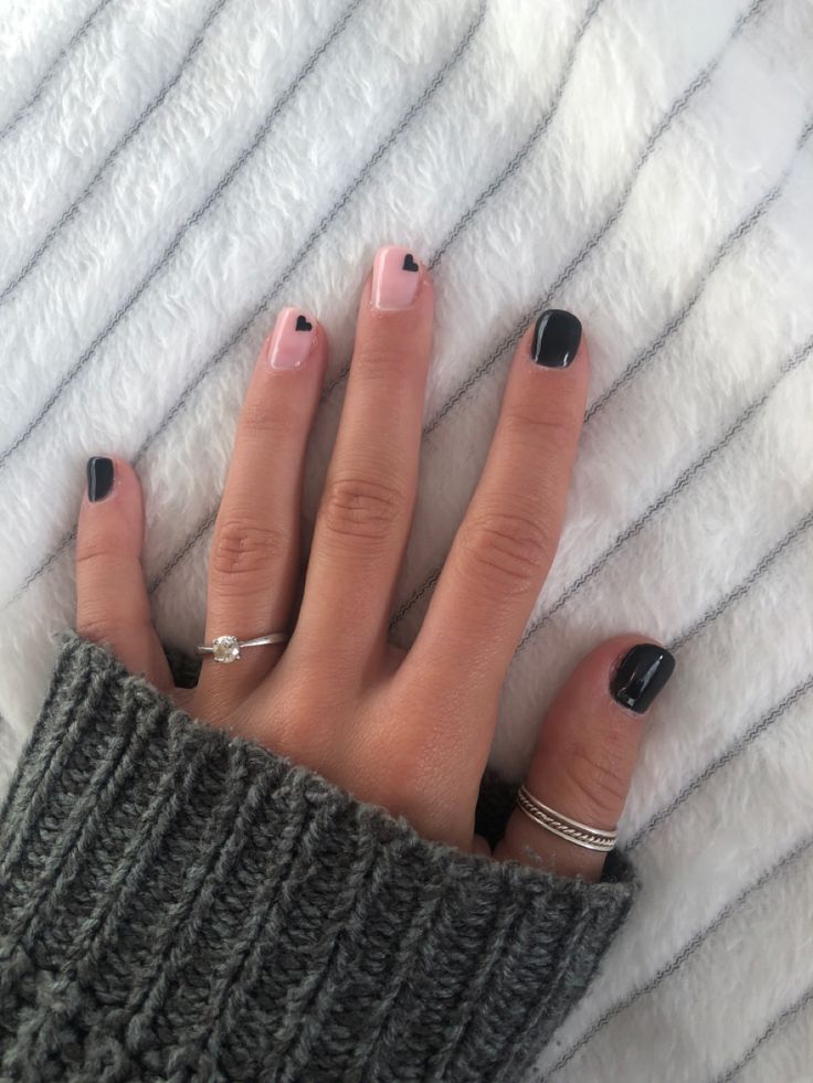 Chic Nail Design: Playful Pastel Pink and Bold Black with Heart Accents